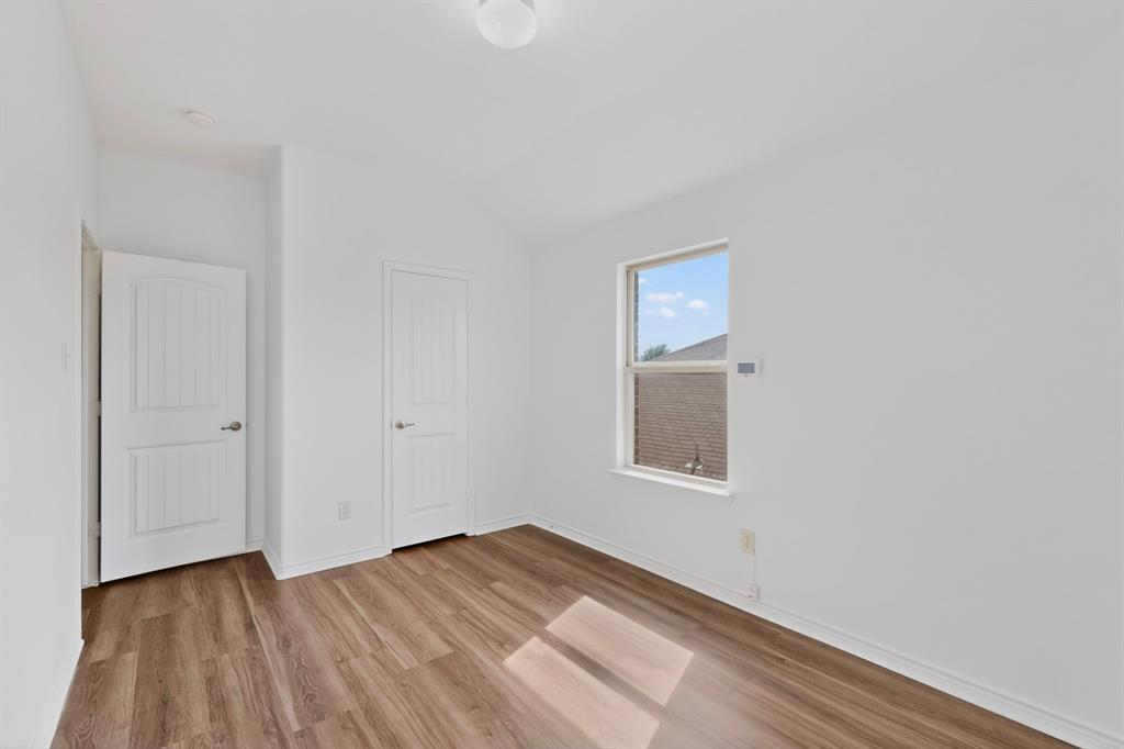 426 Harding Lane Lavon, TX 75166 - Photo 30 of 40 Room with wood-finish flooring, crisp white walls, and a single-pane window
