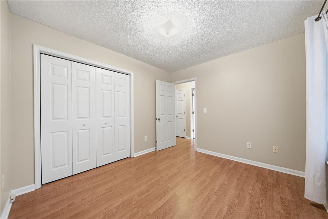 101 Grand Oak Circle Pendleton, SC 29670 - Photo 21 of 40 A well-lit bedroom with durable wood flooring and ample closet space awaits customization.