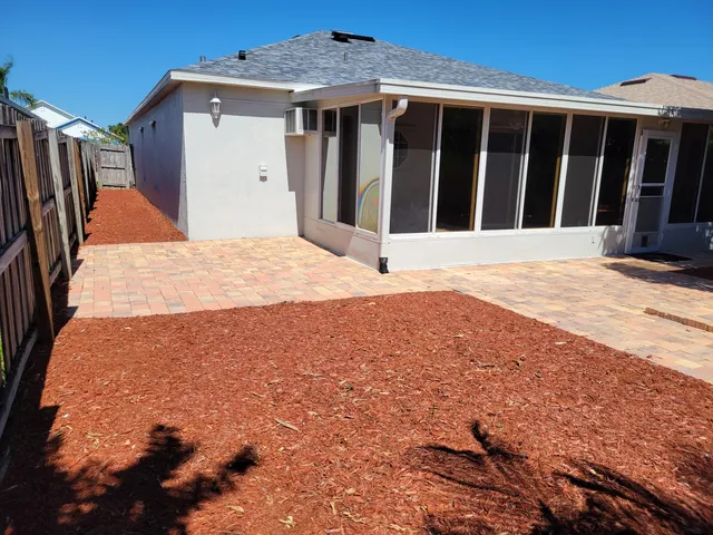a view of a house with wooden fence