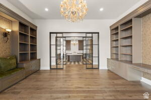 1141 East Lost Ridge Drive Washington, UT 84780 - Photo 53 of 108 Open-concept living space with wood-finish flooring, a decorative chandelier, recessed lighting, and built-in shelving with integrated cabinetry