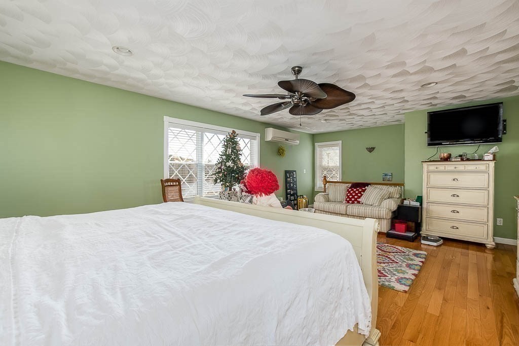 26 Washington Drive Wareham, MA 02571 - Photo 19 of 42 a bedroom with a bed and a flat tv screen on dresser