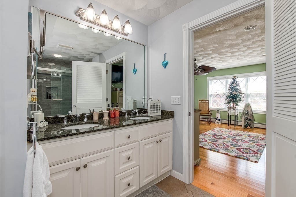 26 Washington Drive Wareham, MA 02571 - Photo 21 of 42 a bathroom with a double vanity sink and a mirror