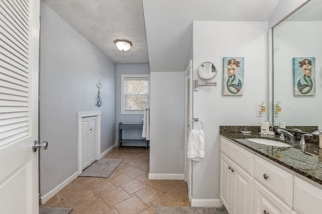 26 Washington Drive Wareham, MA 02571 - Photo 22 of 42 a bathroom with a granite countertop sink a mirror and a refrigerator