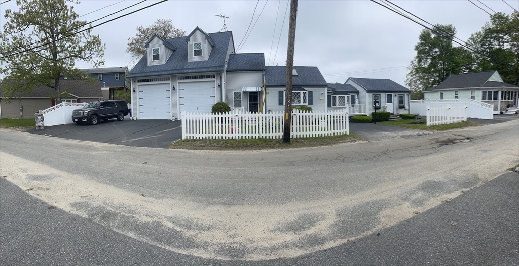 26 Washington Drive Wareham, MA 02571 - Photo 27 of 42 a front view of a house with a garden and parking