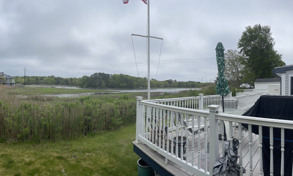 26 Washington Drive Wareham, MA 02571 - Photo 37 of 42 a view of a balcony with lake view and wooden floor