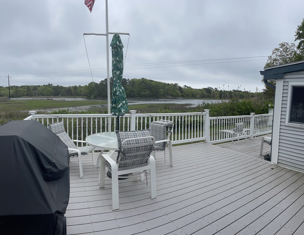 26 Washington Drive Wareham, MA 02571 - Photo 38 of 42 a view of a balcony with wooden floor and outdoor seating