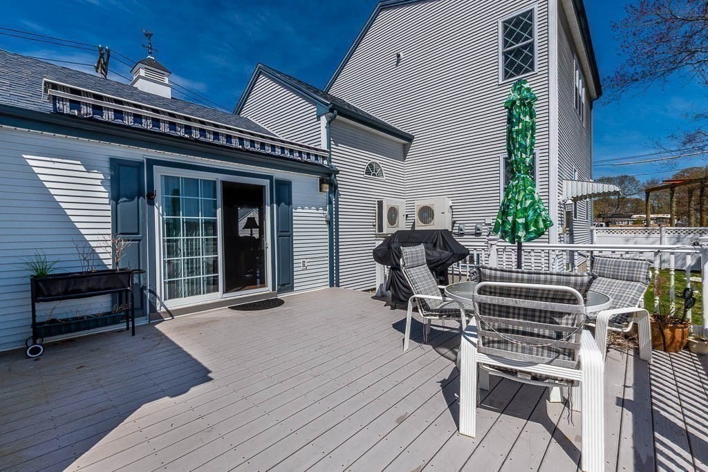 26 Washington Drive Wareham, MA 02571 - Photo 39 of 42 a view of a patio with table and chairs with wooden floor and fence