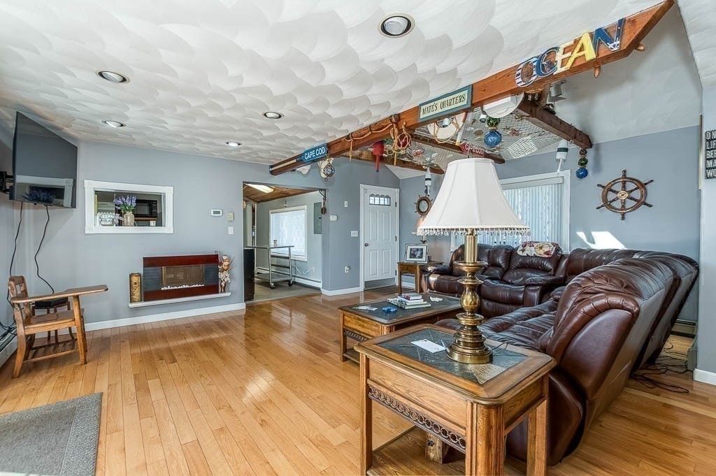26 Washington Drive Wareham, MA 02571 - Photo 4 of 42 a living room with furniture a flat screen tv and a table