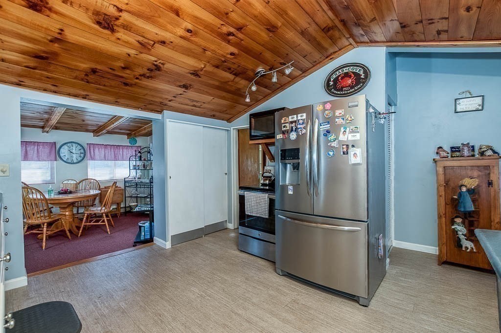 26 Washington Drive Wareham, MA 02571 - Photo 10 of 42 a kitchen with a refrigerator and a table