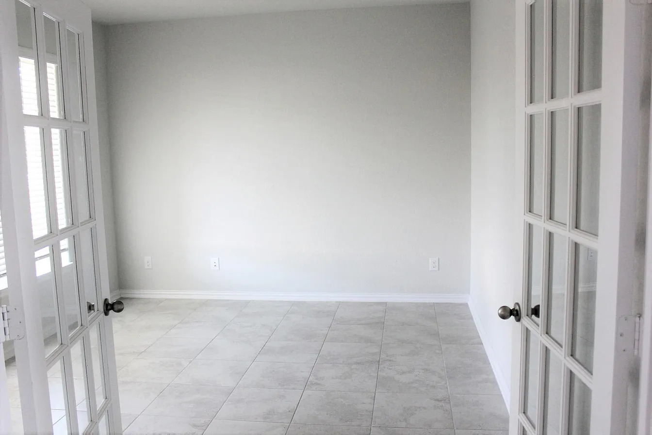 717 Paper Daisy Path Leander, TX 78641 - Photo 6 of 7 French doors open into a versatile space with durable tile flooring, ready for personalization.