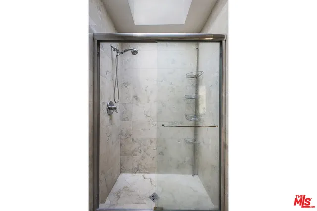 a view of a hallway with entryway and stairs