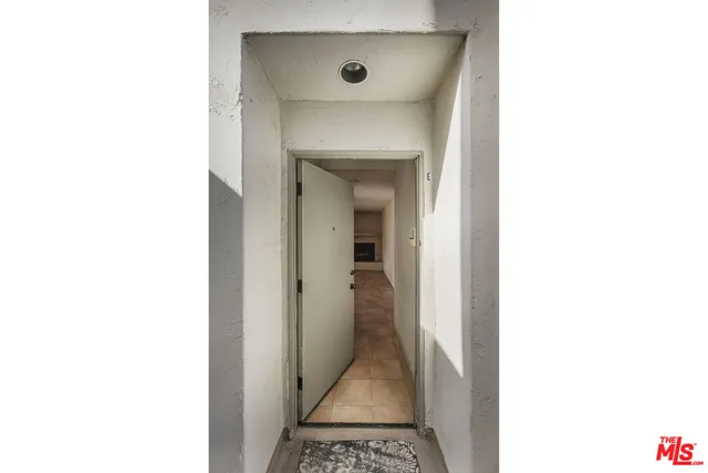 a view of a room with a bench and a potted plant