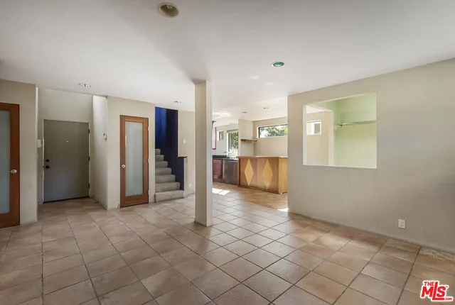 a view of an empty room with a fireplace