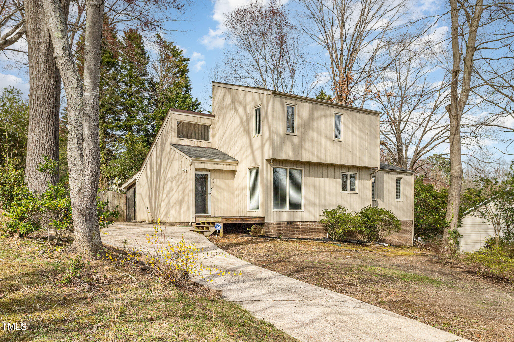 6913 Three Bridges Circle Raleigh, NC 27613 - Photo 2 of 28 a view of a white house with a large tree