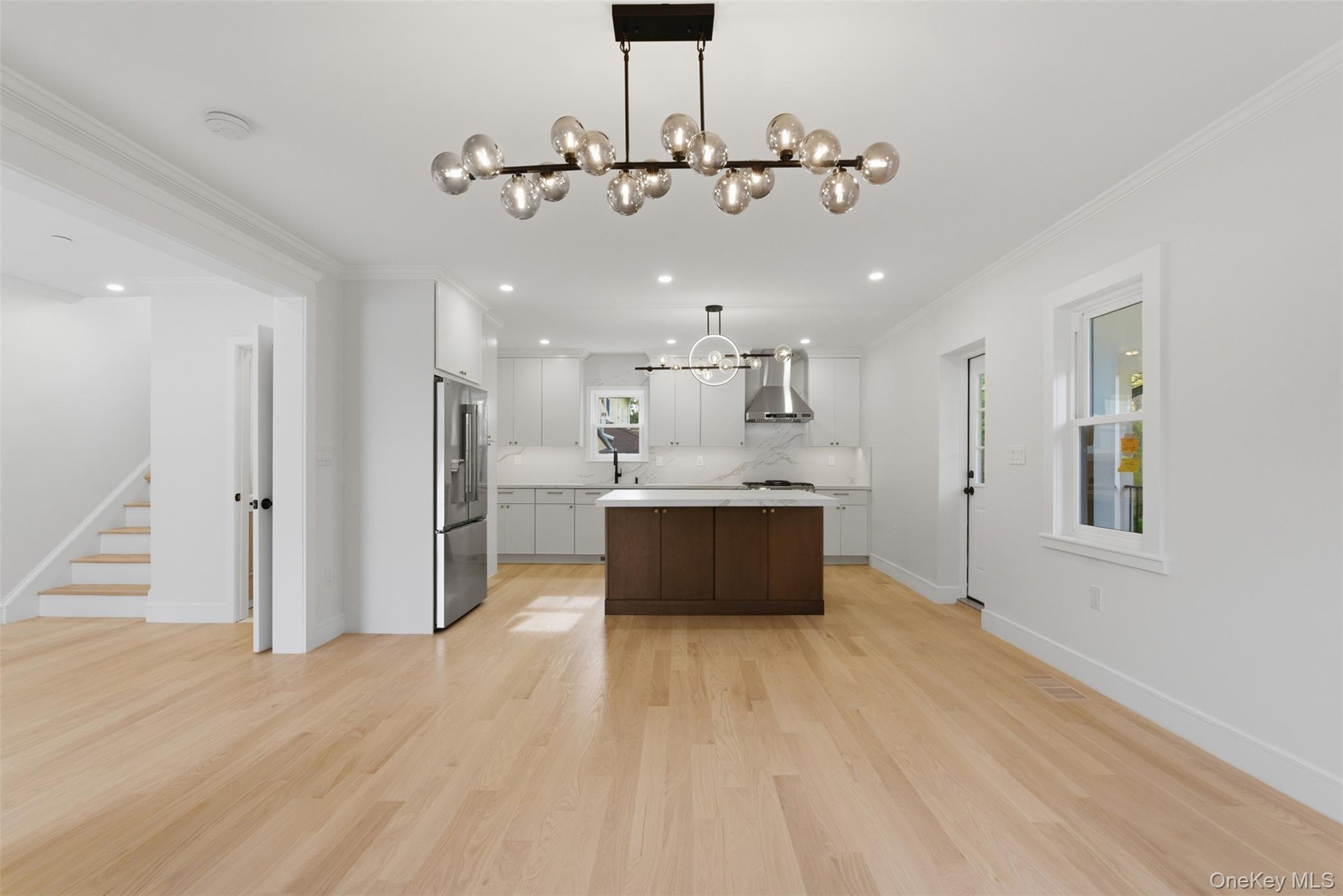 40 Calhoun Avenue New Rochelle, NY 10801 - Photo 5 of 49 Open-concept living space featuring light wood-finish flooring, a contemporary chandelier, and recessed lighting