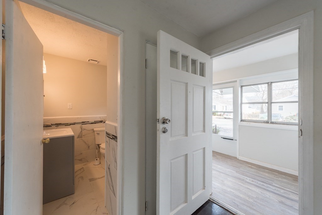84 Lamont Street Springfield, MA 01119 - Photo 12 of 21 a view of a hallway with wooden floor and cabinet