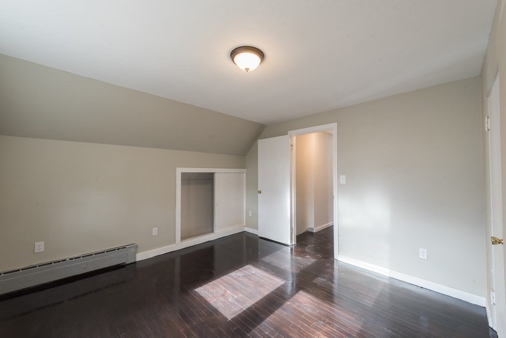 84 Lamont Street Springfield, MA 01119 - Photo 17 of 21 an empty room with wooden floor and windows