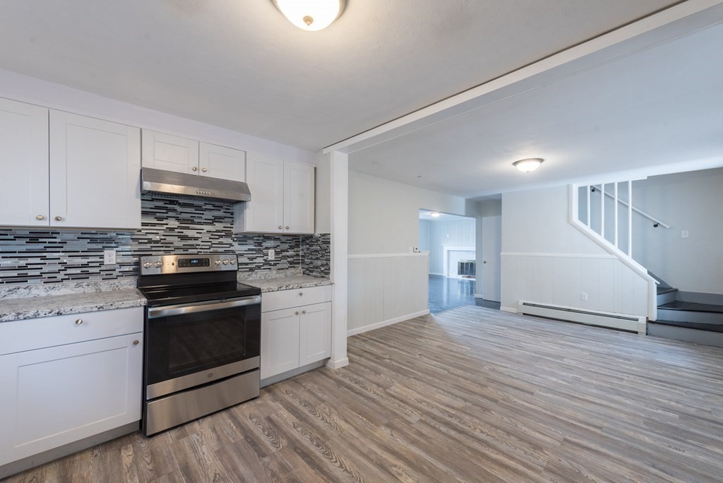 84 Lamont Street Springfield, MA 01119 - Photo 2 of 21 a kitchen with granite countertop a stove and a sink