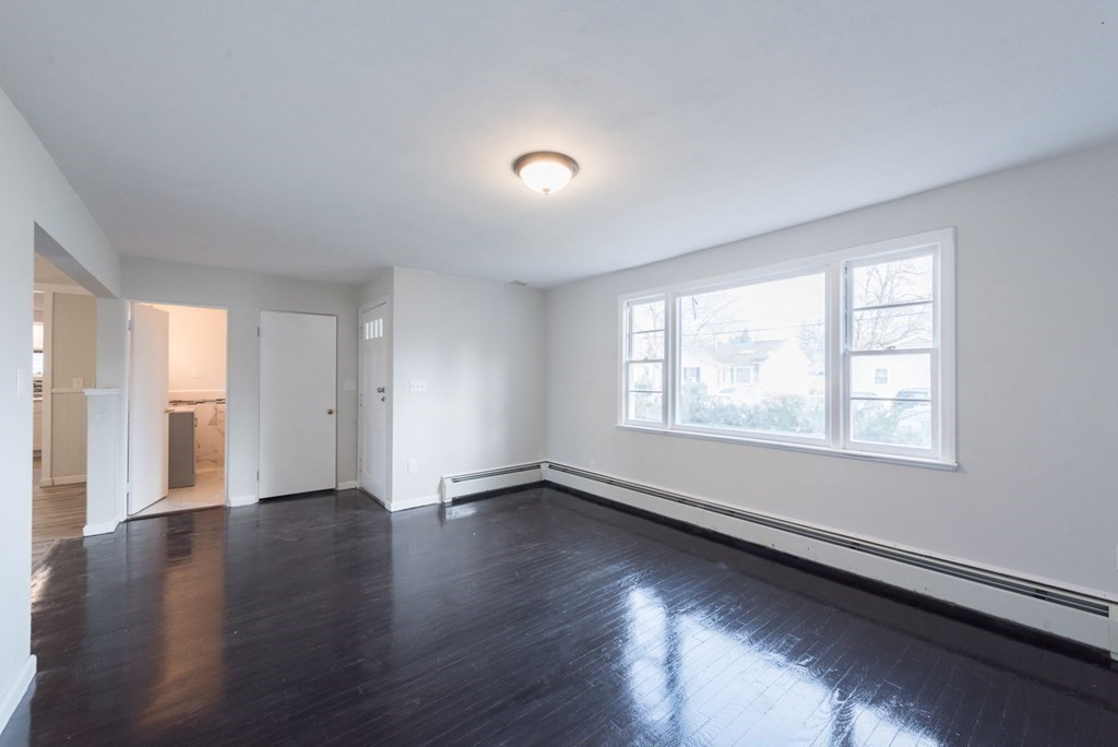 84 Lamont Street Springfield, MA 01119 - Photo 8 of 21 an empty room with wooden floor and windows