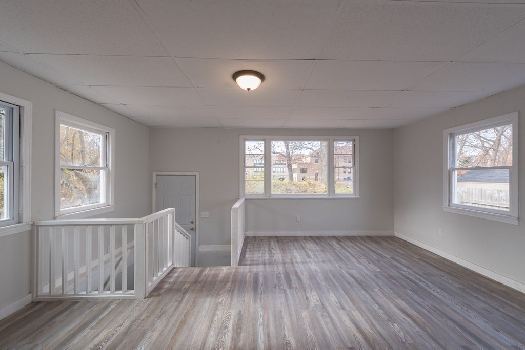 84 Lamont Street Springfield, MA 01119 - Photo 10 of 21 a view of an empty room with wooden floor and window