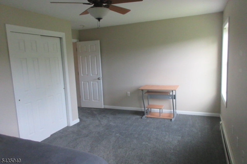 28 Beaver Run Road Lafayette, NJ 07848 - Photo 20 of 36 an empty room with a ceiling fan and carpet