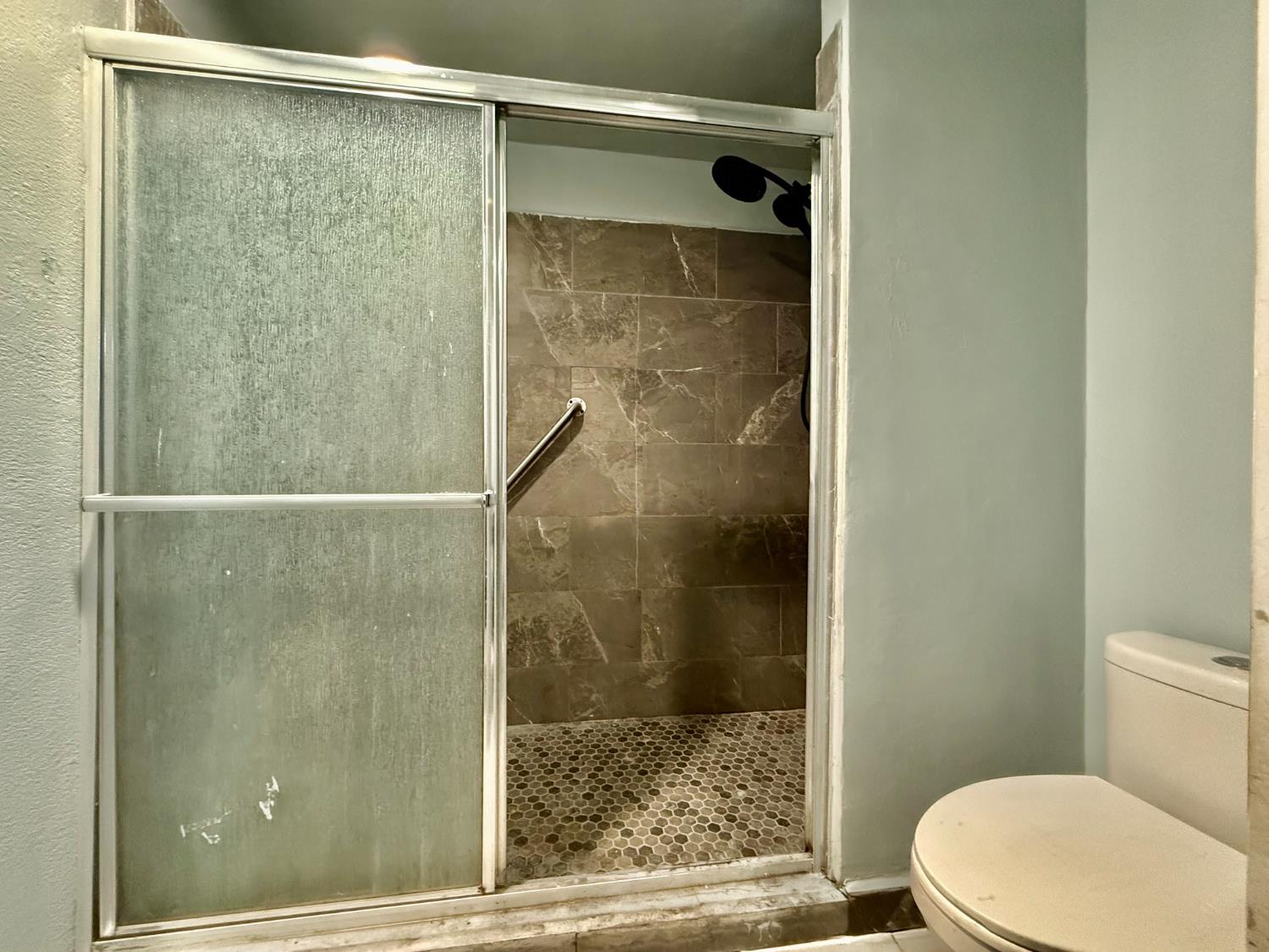 1401 Inyo Avenue Modesto, CA 95358 - Photo 11 of 16 a bathroom with a shower and a toilet