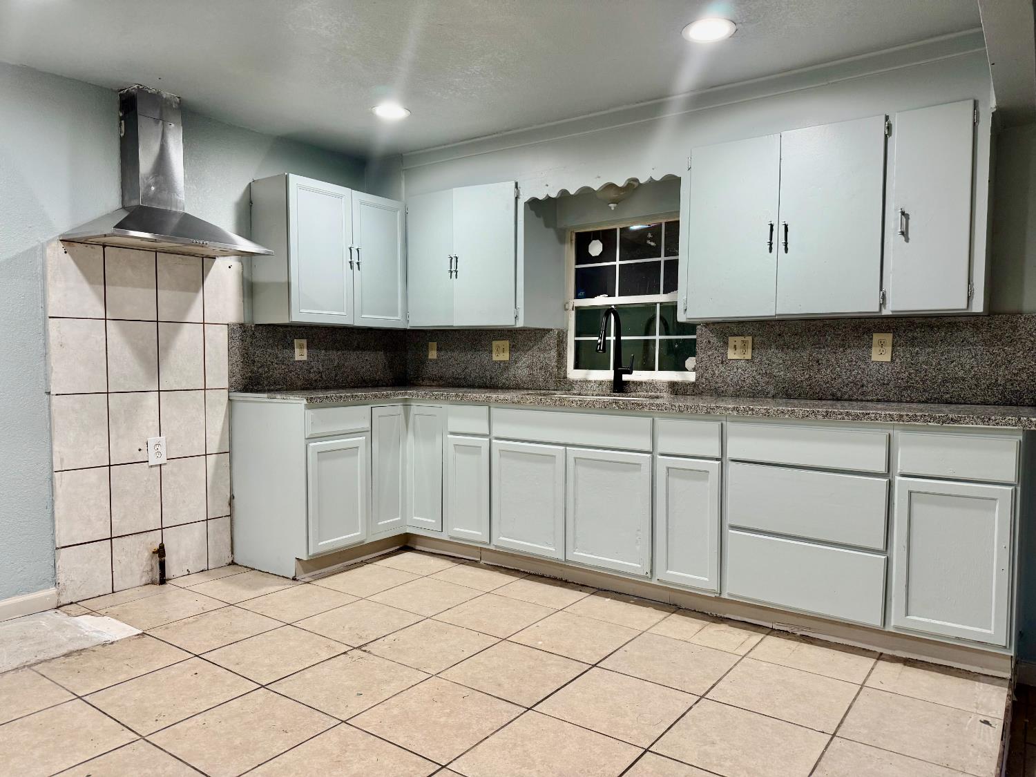 1401 Inyo Avenue Modesto, CA 95358 - Photo 2 of 16 a kitchen with granite countertop a sink and cabinets