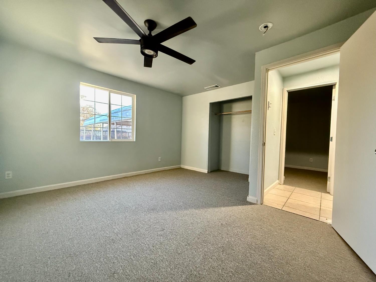 1401 Inyo Avenue Modesto, CA 95358 - Photo 7 of 16 a view of a livingroom with a ceiling fan and window
