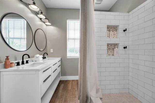 a bathroom with a double vanity sink and a mirror
