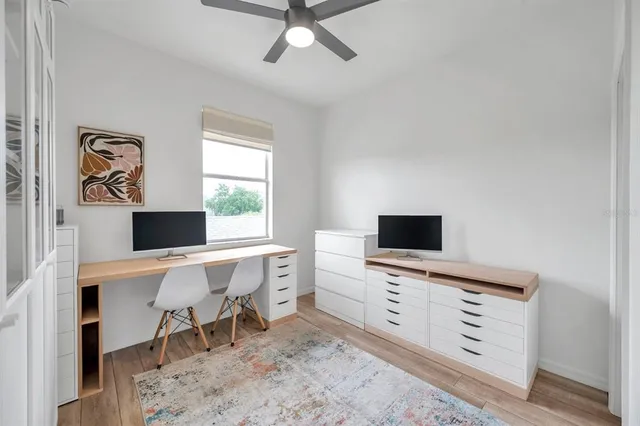 a view of a workspace with furniture and a window