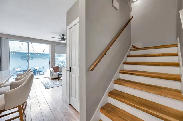 a view of staircase with living room and wooden floor