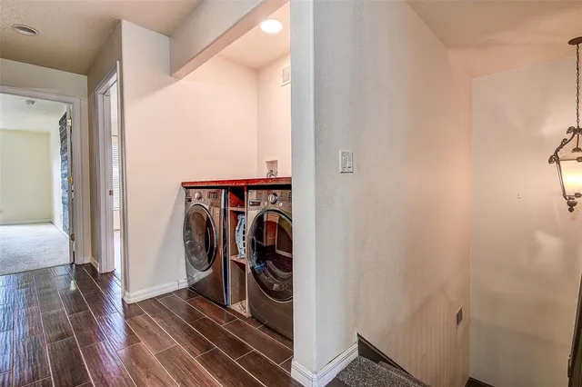 a view of a storage and utility room with wooden floor