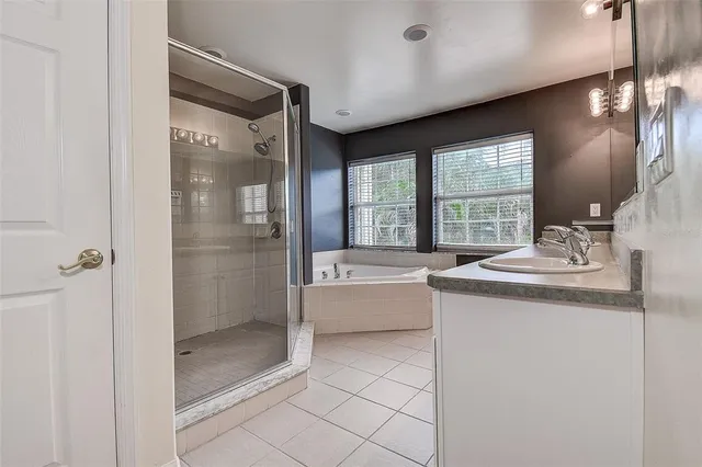 a bathroom with a granite countertop sink a toilet and shower