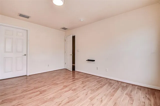 an empty room with wooden floor