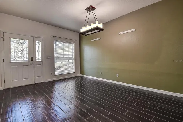 a view of wooden floor and windows in a room