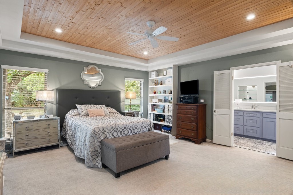 1709 Crested Butte Drive Austin, TX 78746 - Photo 12 of 40 a bedroom with a bed and furniture