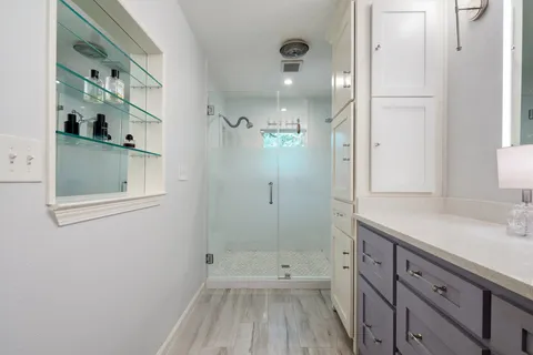 a bathroom with a sink a toilet and shower