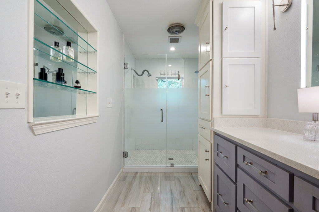 1709 Crested Butte Drive Austin, TX 78746 - Photo 14 of 40 a bathroom with a sink a toilet and shower