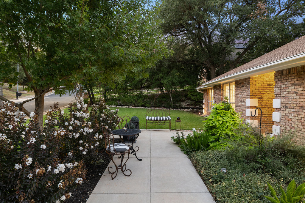 1709 Crested Butte Drive Austin, TX 78746 - Photo 17 of 40 a view of a patio with a table and chairs and potted plants