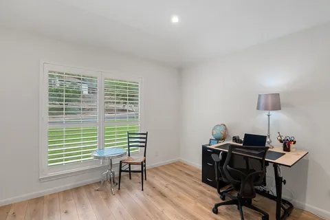 a workspace with furniture and a window