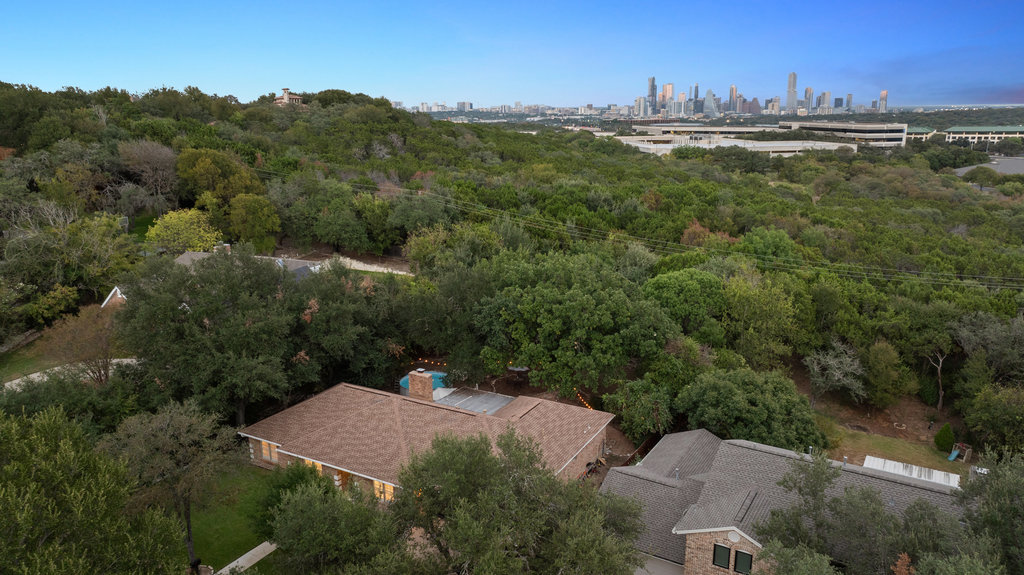 1709 Crested Butte Drive Austin, TX 78746 - Photo 2 of 40 an aerial view of residential houses with outdoor space and trees