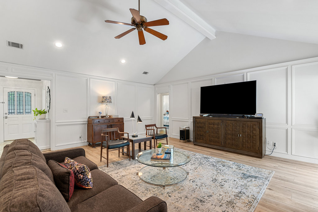 1709 Crested Butte Drive Austin, TX 78746 - Photo 24 of 40 a living room with furniture and a flat screen tv