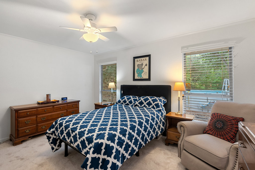 1709 Crested Butte Drive Austin, TX 78746 - Photo 28 of 40 a bedroom with bed and window