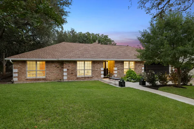 a view of a house with a yard and sitting area