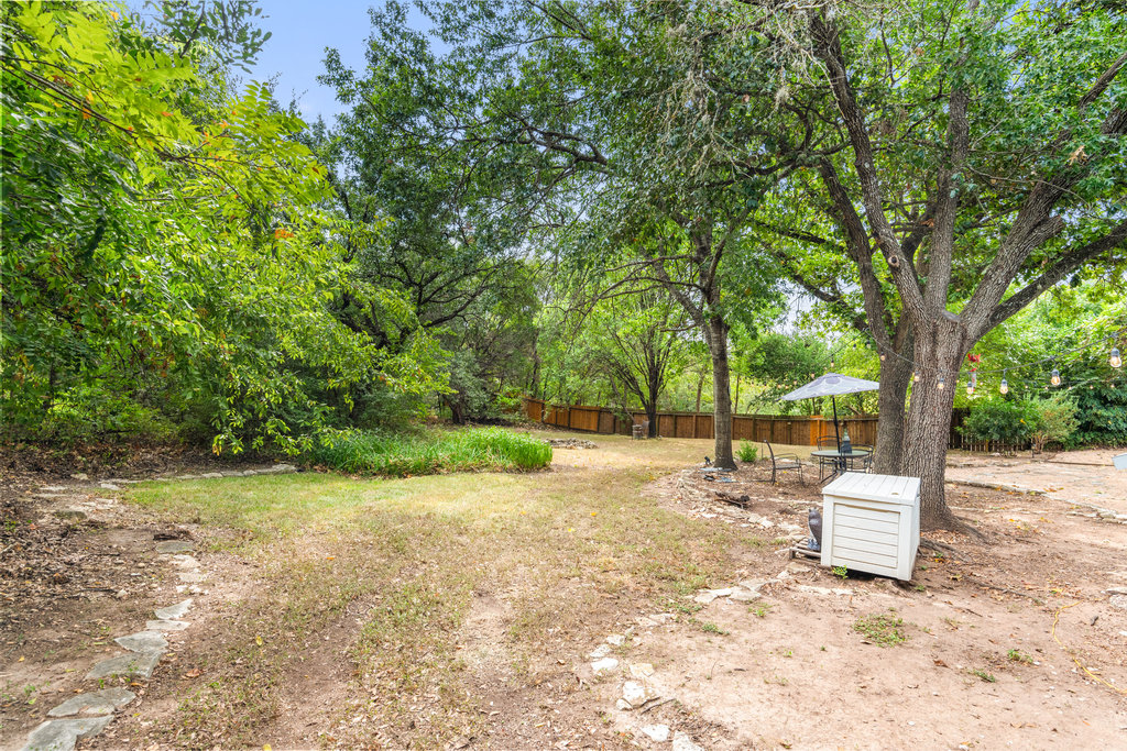 1709 Crested Butte Drive Austin, TX 78746 - Photo 35 of 40 a wooden bench with tree in the background