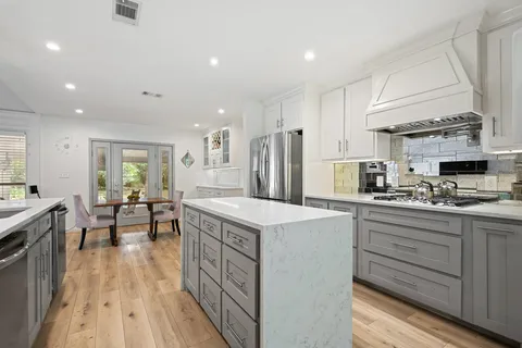 a kitchen with counter top space sink and stainless steel appliances