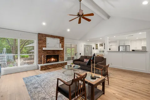 a living room with furniture and a fireplace