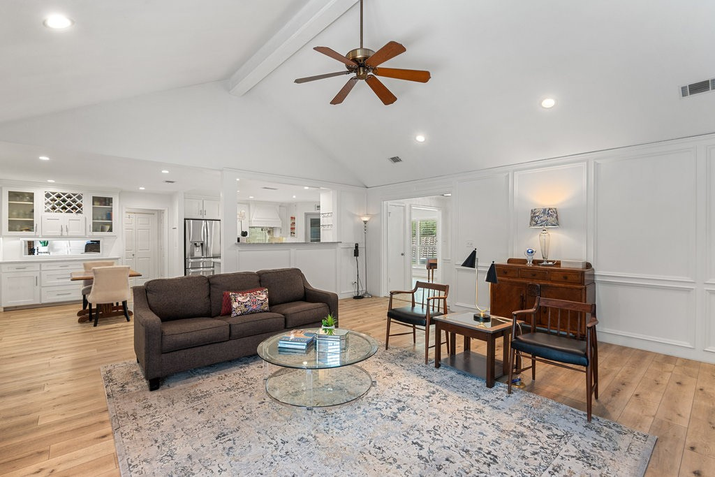1709 Crested Butte Drive Austin, TX 78746 - Photo 10 of 40 a living room with furniture and a dining table with wooden floor