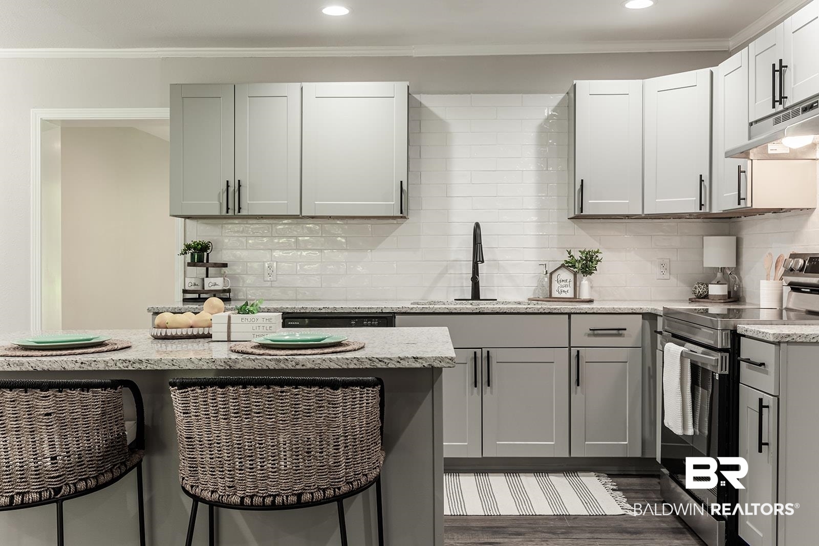 4626 Gold Drive Mobile, AL 36619 - Photo 6 of 48 Kitchen with tasteful backsplash, stainless steel electric range oven, a kitchen breakfast bar, dark wood-type flooring, and ornamental molding