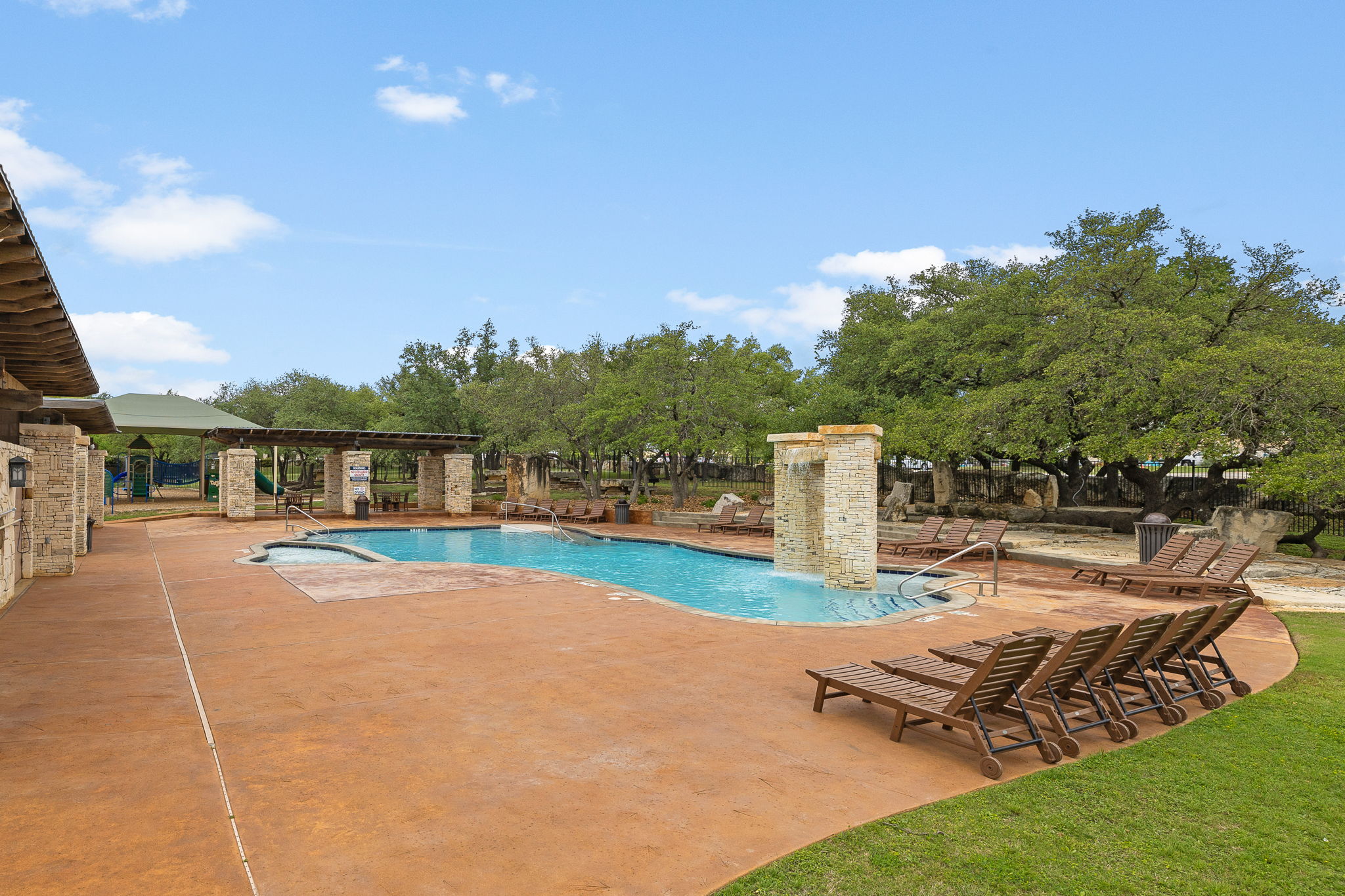 3609 Goodnight Trail Leander, TX 78641 - Photo 38 of 39 a view of a swimming pool with an outdoor seating and a garden
